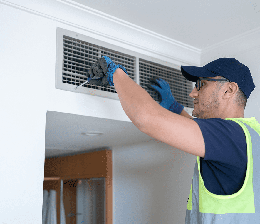 Worker maintaining HVAC system