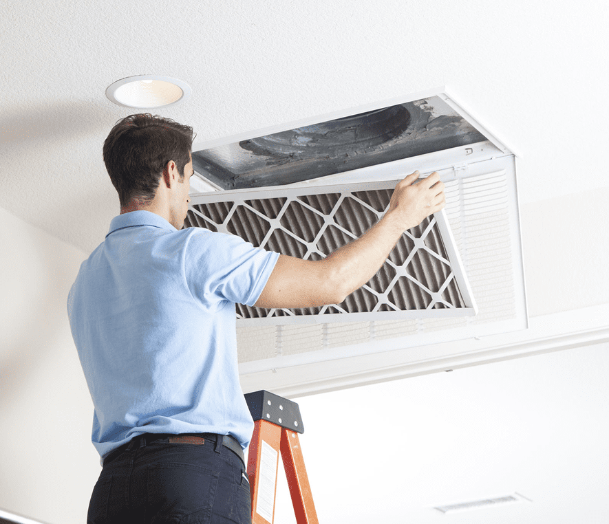 Person changing home air filter