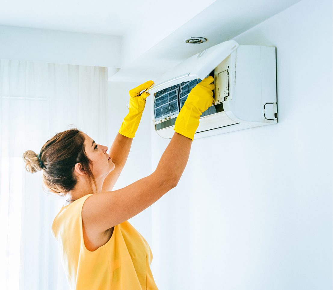 Air conditioning maintenance by a woman