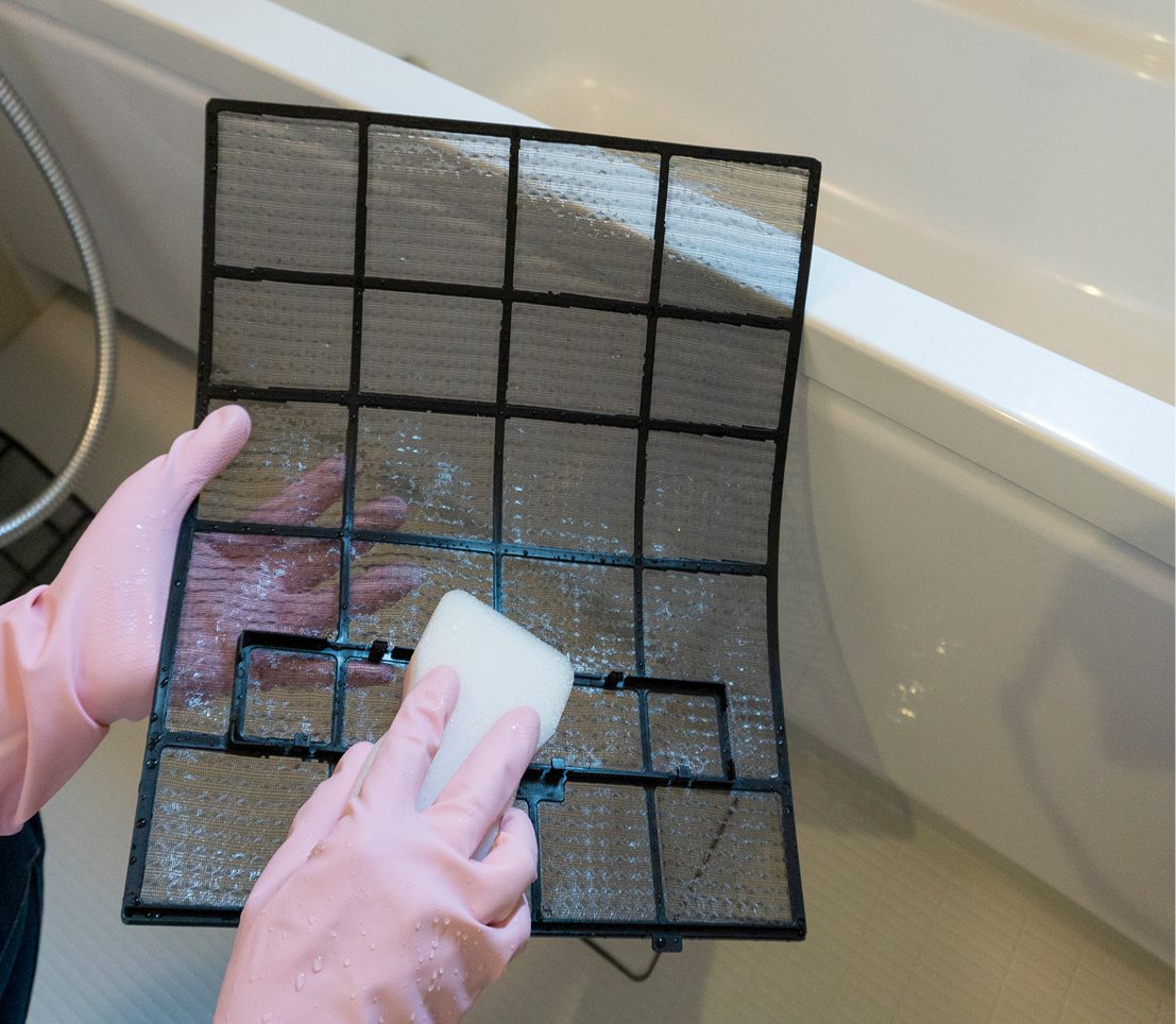 Pink gloves cleaning air filter